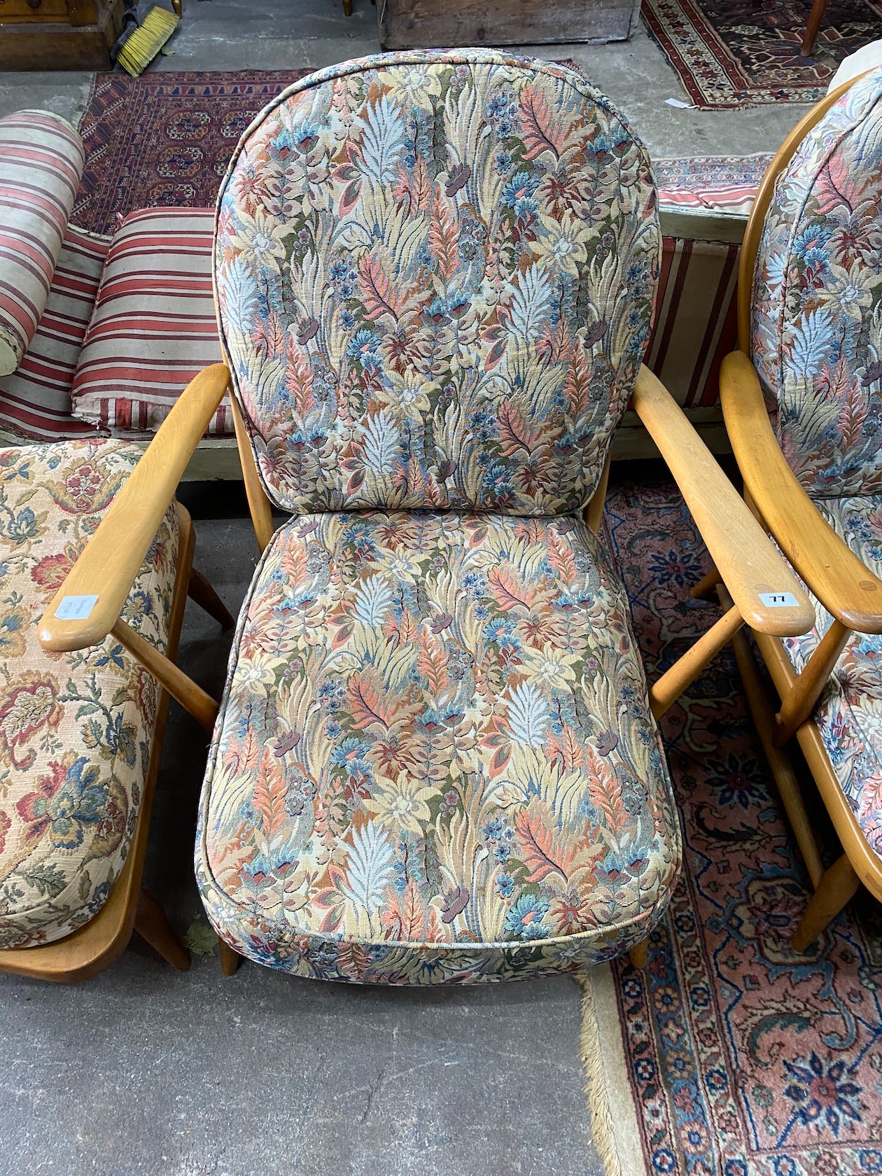 An Ercol beech three piece lounge suite and footstool, settee length 174cm, width 80cm, height 82cm